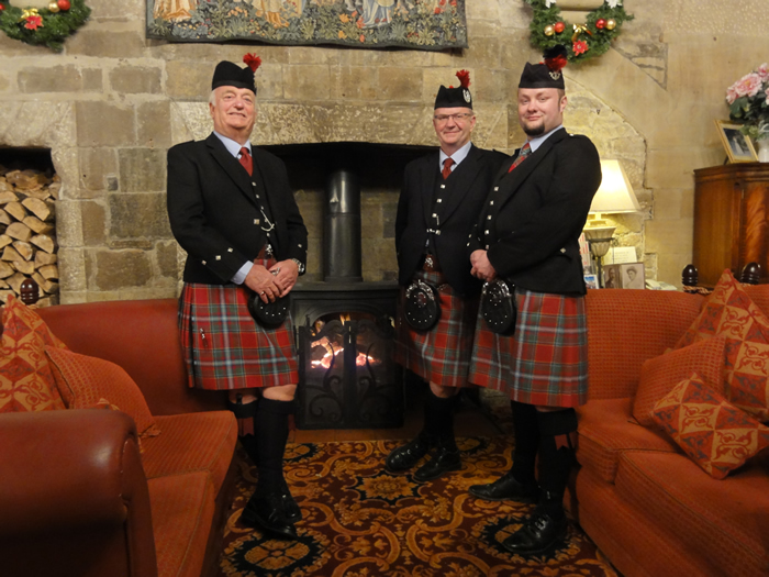 Wedding pipers and drummers at the fireside